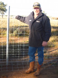 graham-chambers-with-the-exclusion-fence-he-erected-on-his-western-queensland-property